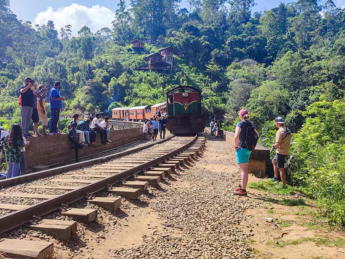 Tourists watching train crossing at Nine Arch Bridge
