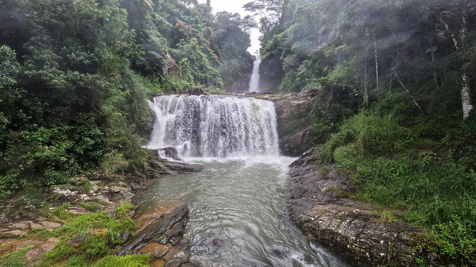 Kadiyanlena Waterfall cascading beneath an old arch bridge in Nuwara Eliya District